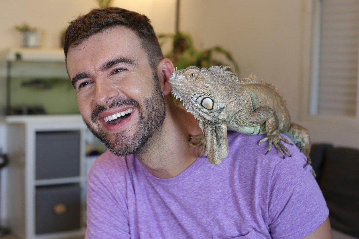 man and pet lizard