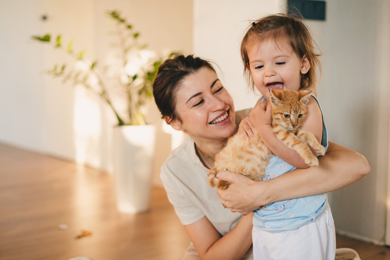 mom and daughter with pet cat